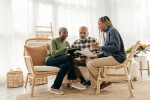 Young African American woman helping her parents on an iPad